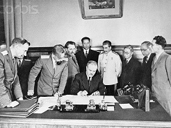 16 Jan 1946 --- Signing of treaty of friendship and alliance between Soviet Union and Chinese Rep. looking on as V.M. Molotov signs the treaty are J.V. Stalin, S.A. Lozovsky, Dr. T.V. Soong, Mr. Wang Shi-Tse, Mr. Foo Ping-Sheung, A.A. Petrov, USSR Ambassador to China and others. --- Image by © Bettmann/CORBIS